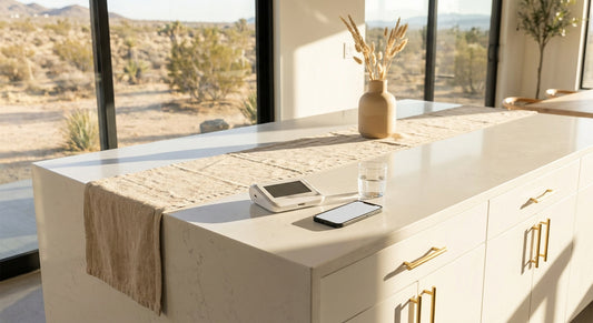 A discreet at-home medical test kit resting on a clean white countertop in a softly lit, modern home interior.